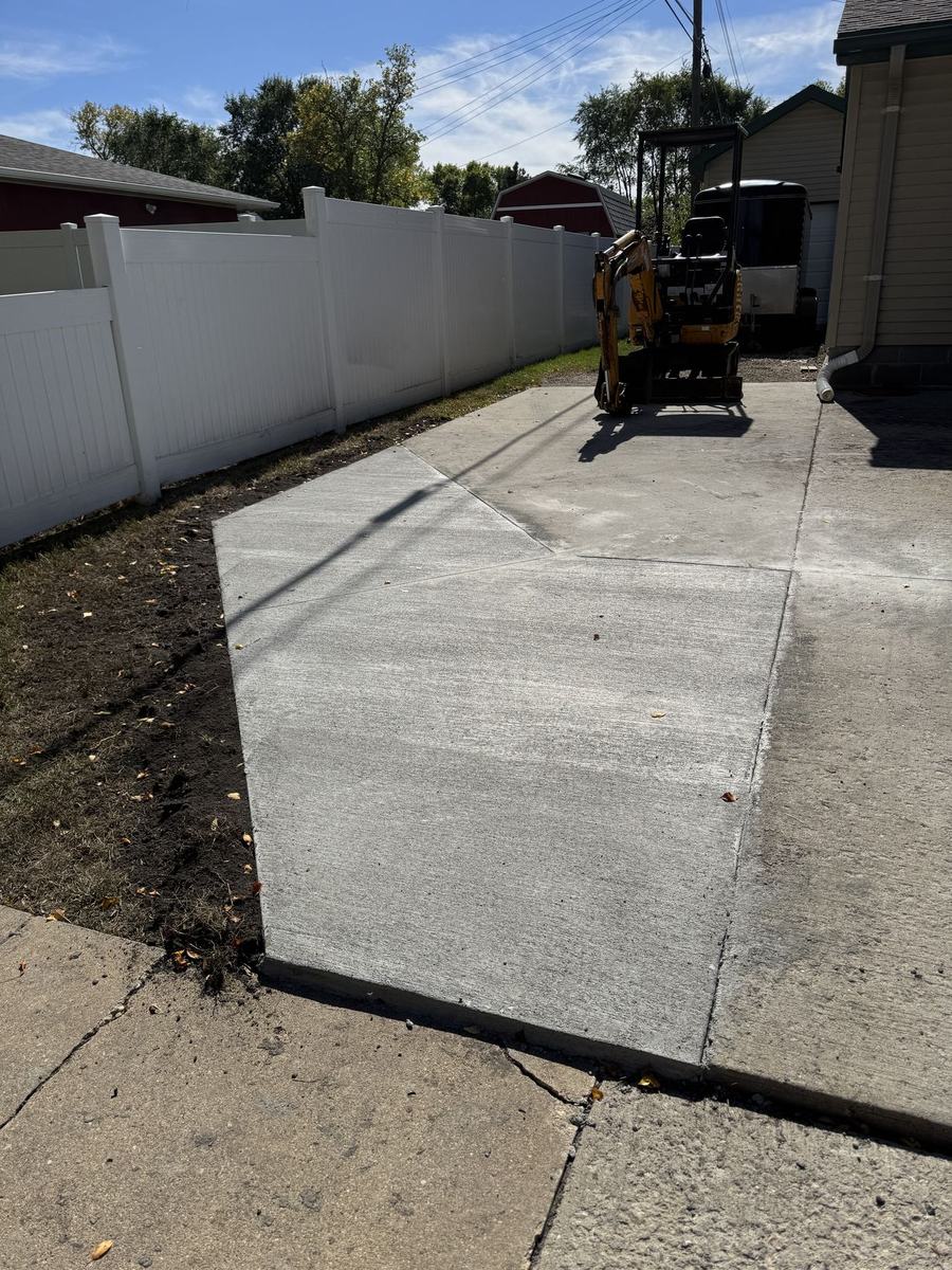 Finished concrete driveway along the fence line
