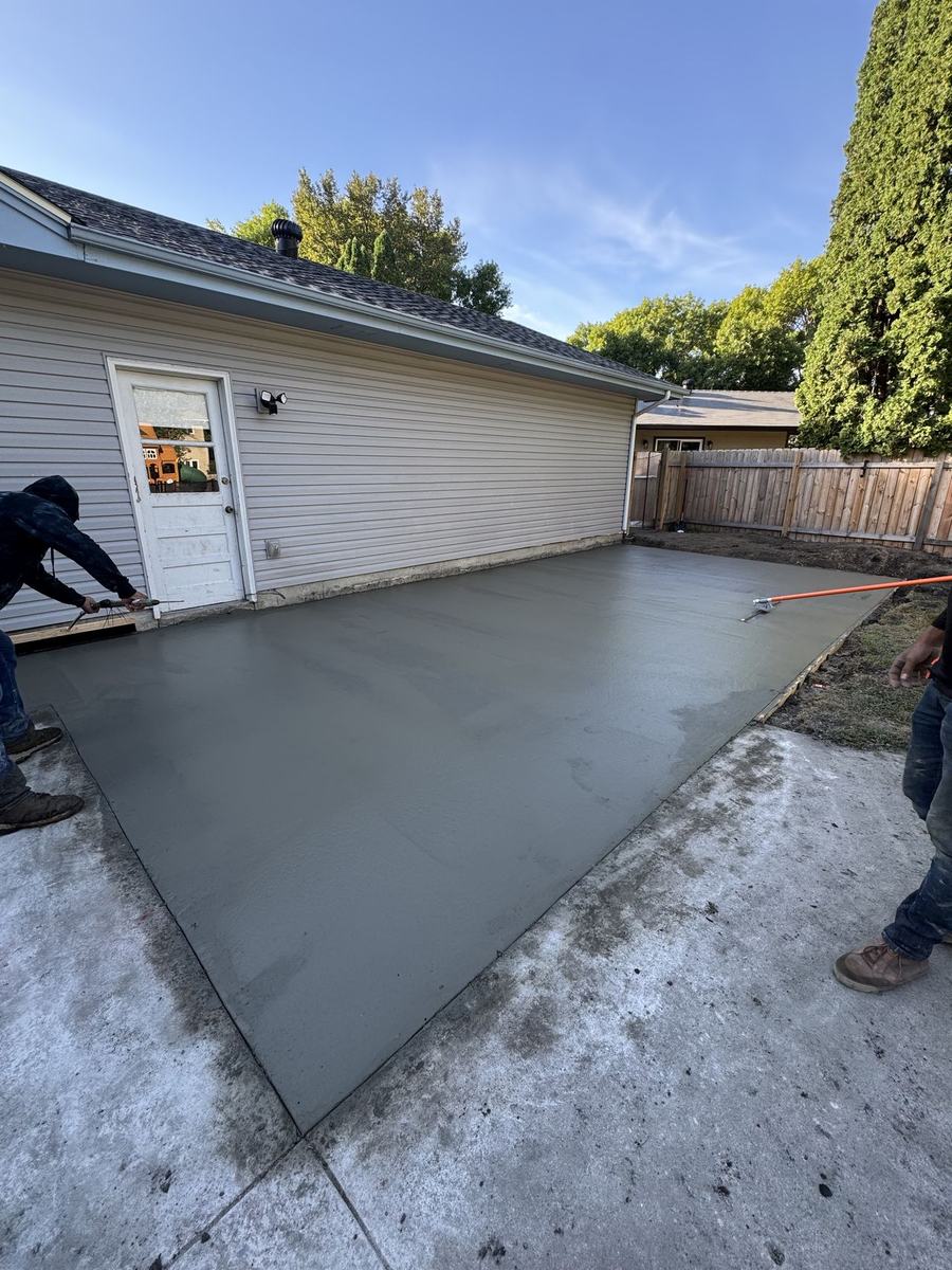 Concrete pad finished beside a house