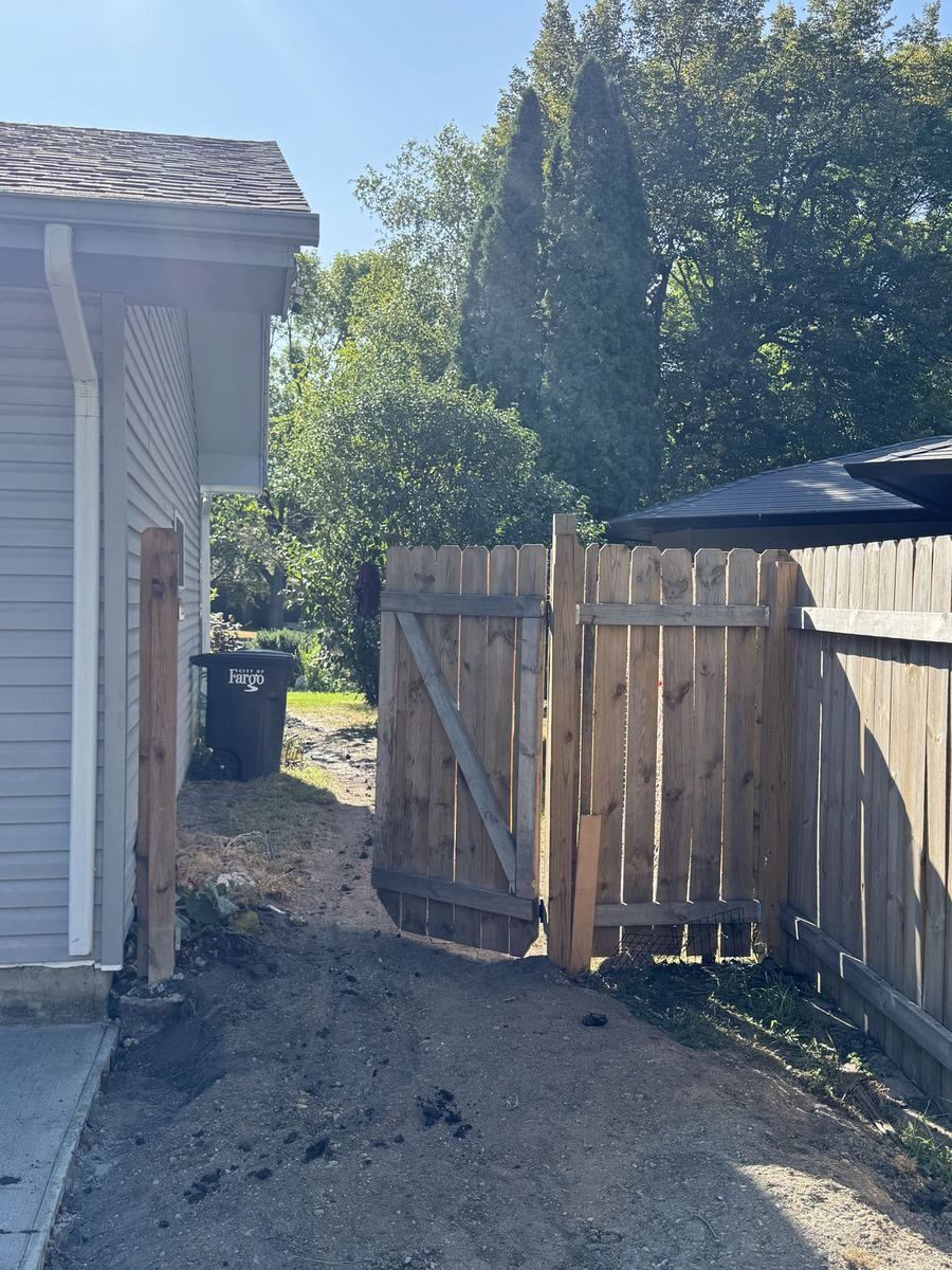 Wood privacy fence with gate installed by OARA