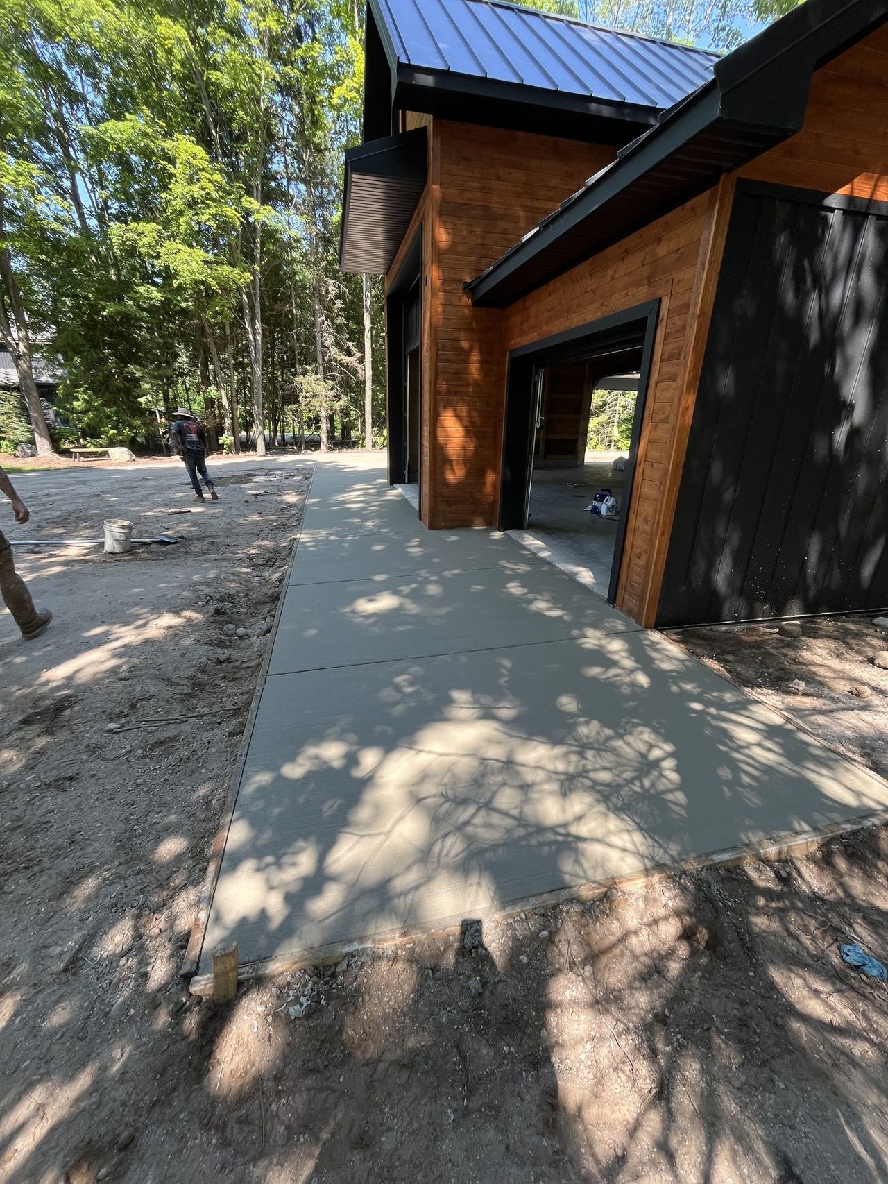 Concrete apron and site work beside a new home