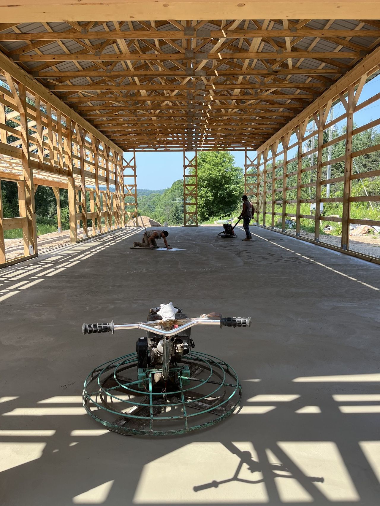 OARA crew power-troweling a concrete floor in a pole barn near Fargo, ND