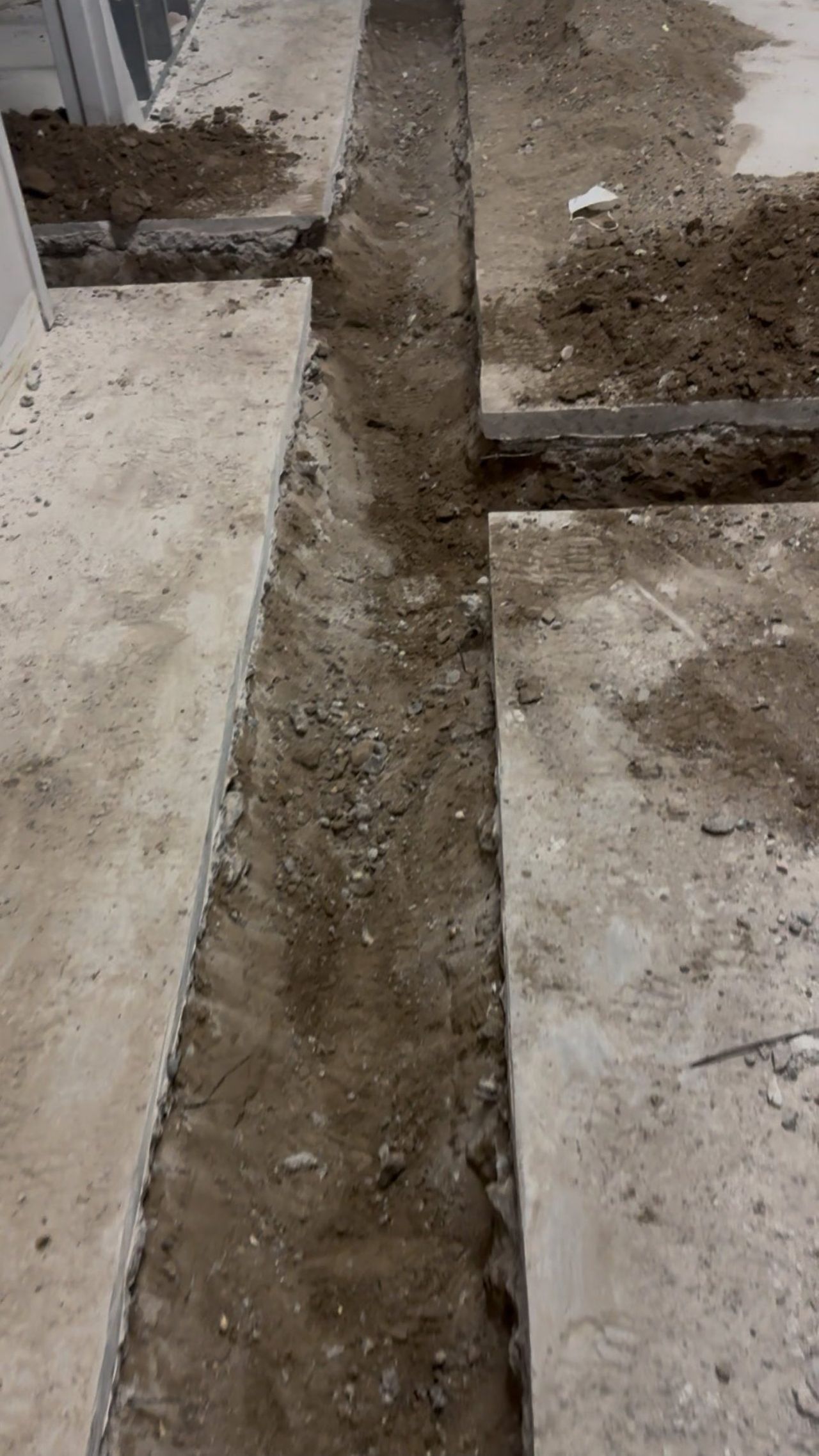 Open slab trench excavated and ready for pipe and backfill