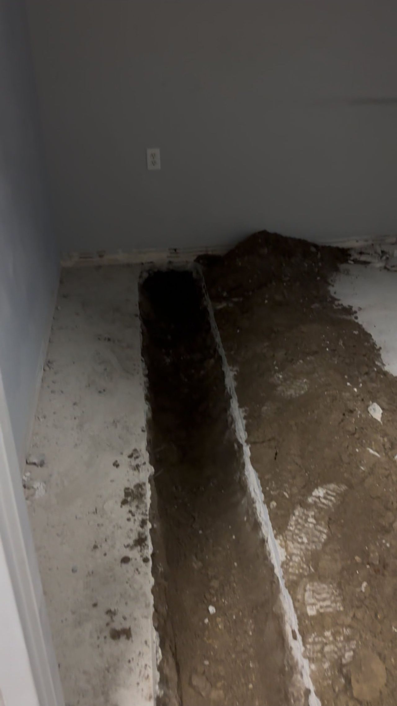 Narrow trench cut along an interior wall